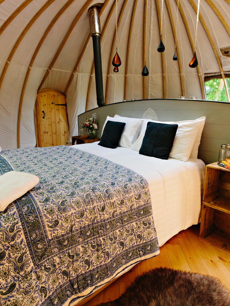 Double bed in a glamping dome.