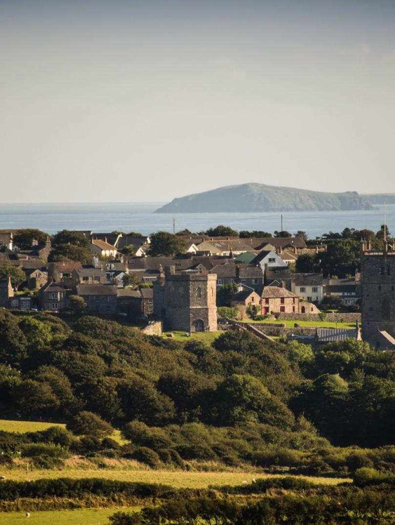 view of St Davids countryside, with cathedral and blue sea in the background.