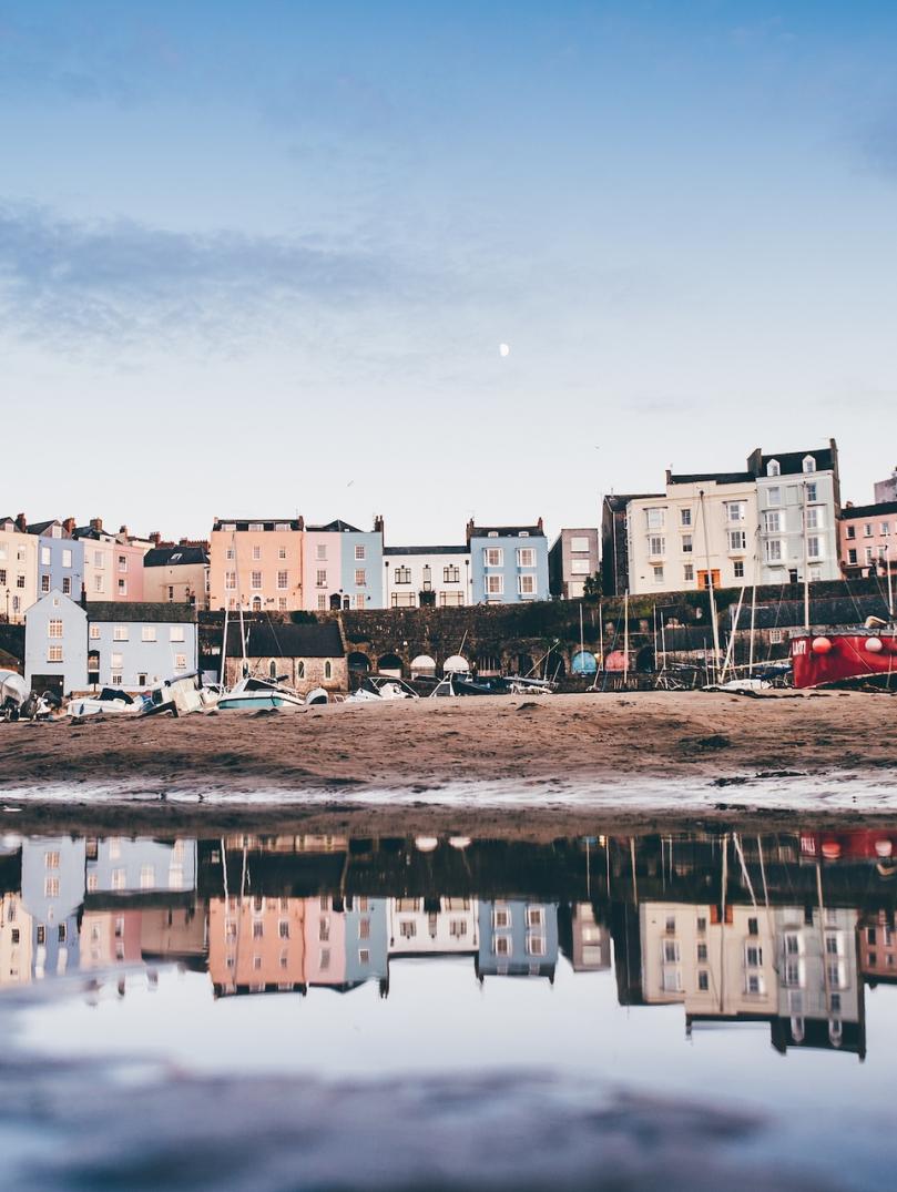 Tenby Harbour at low tide with reflection in water