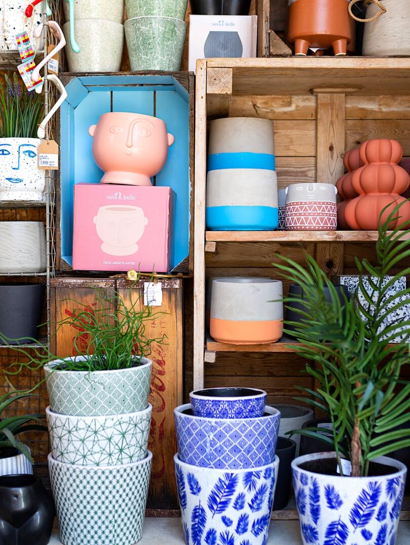 Inside a shop with colourful plant pots on display.