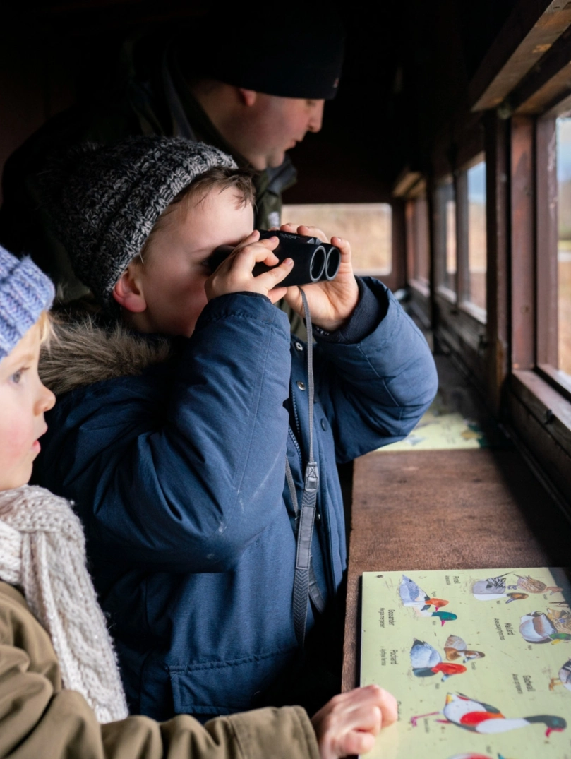 family bird watching in hide