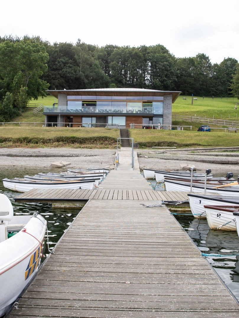 boats and jetty, with visitor centre in background.