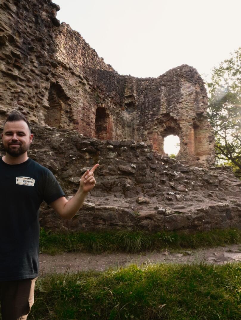 man stood in front of castle.