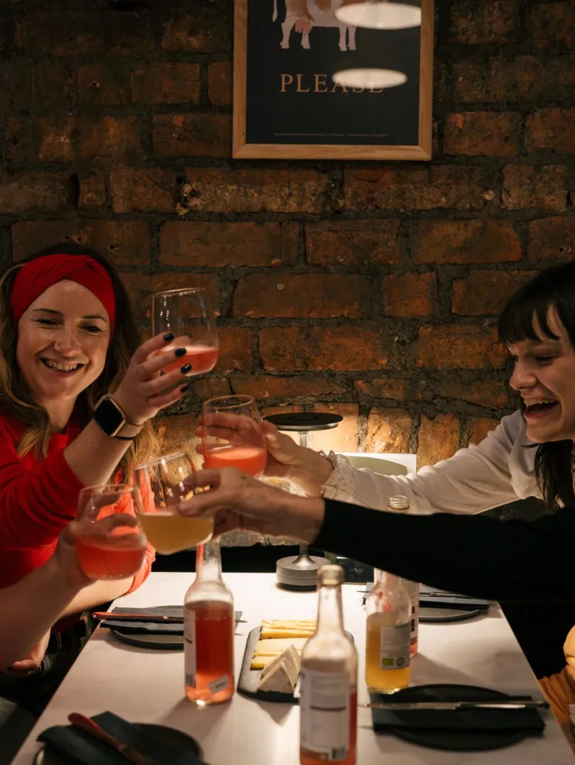 group of women and girl at table with drinks.
