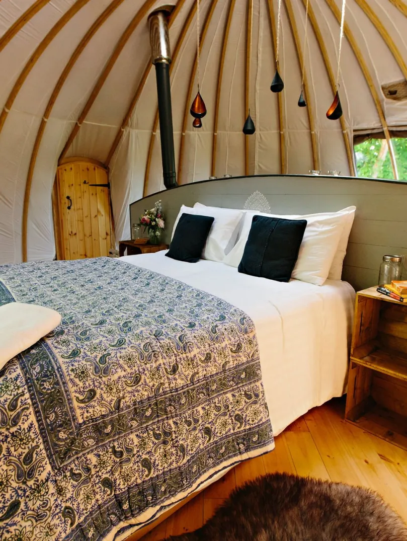 Double bed in a glamping dome.