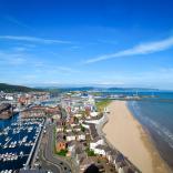 Sweeping view of the harbour and coastline of Swansea Bay.
