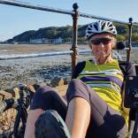 Woman on a recumbent trike on a seafront 