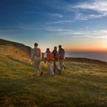 Four walkers enjoying the sunset along the Glamorgan Heritage Coast.