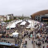 Rows of stalls with crowds of people enjoying Cardiff Bay Food Festival.