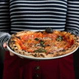Freshly cooked crispy pizza on a plate.