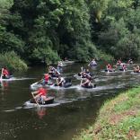 A group of people racing in coracles in West Wales