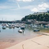 Boats in Saundersfoot harbour on a sunny day.