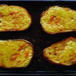 Slices of Welsh rarebit on a tray.