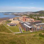 An aerial shot of Swansea University Bay Campus with views across the bay.