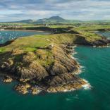Nefyn golf course surrounded by the sea and mountains.