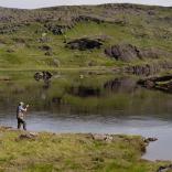 A man fishing by a lake.