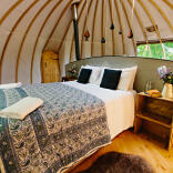Double bed in a glamping dome.
