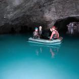 Image of a group of people floating in a boat on an underground lake