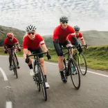 group of cyclists on mountain road.