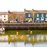 people sat on wall, Aberaeron harbour.