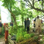 Film crew filming in woodland.