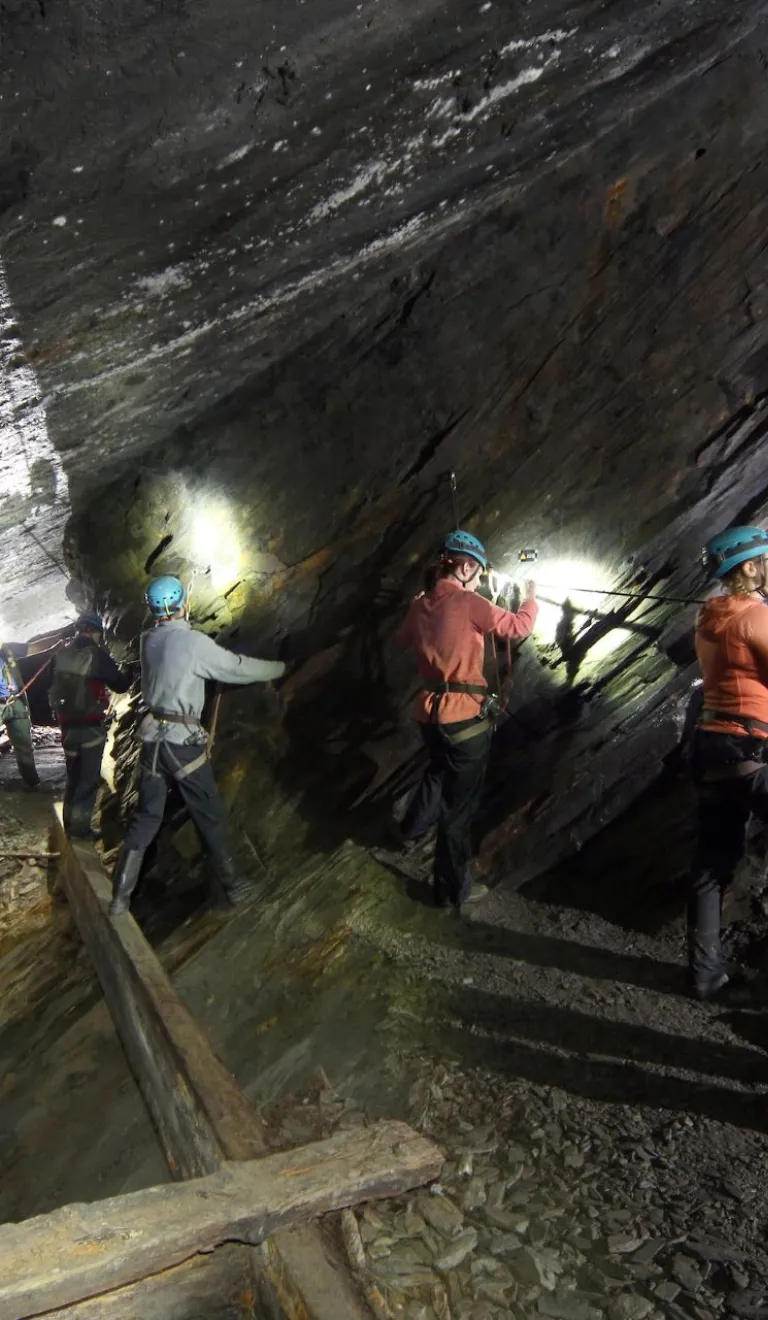 Teams traverse on of the underground bridges at Go Below Xtreme experience.
