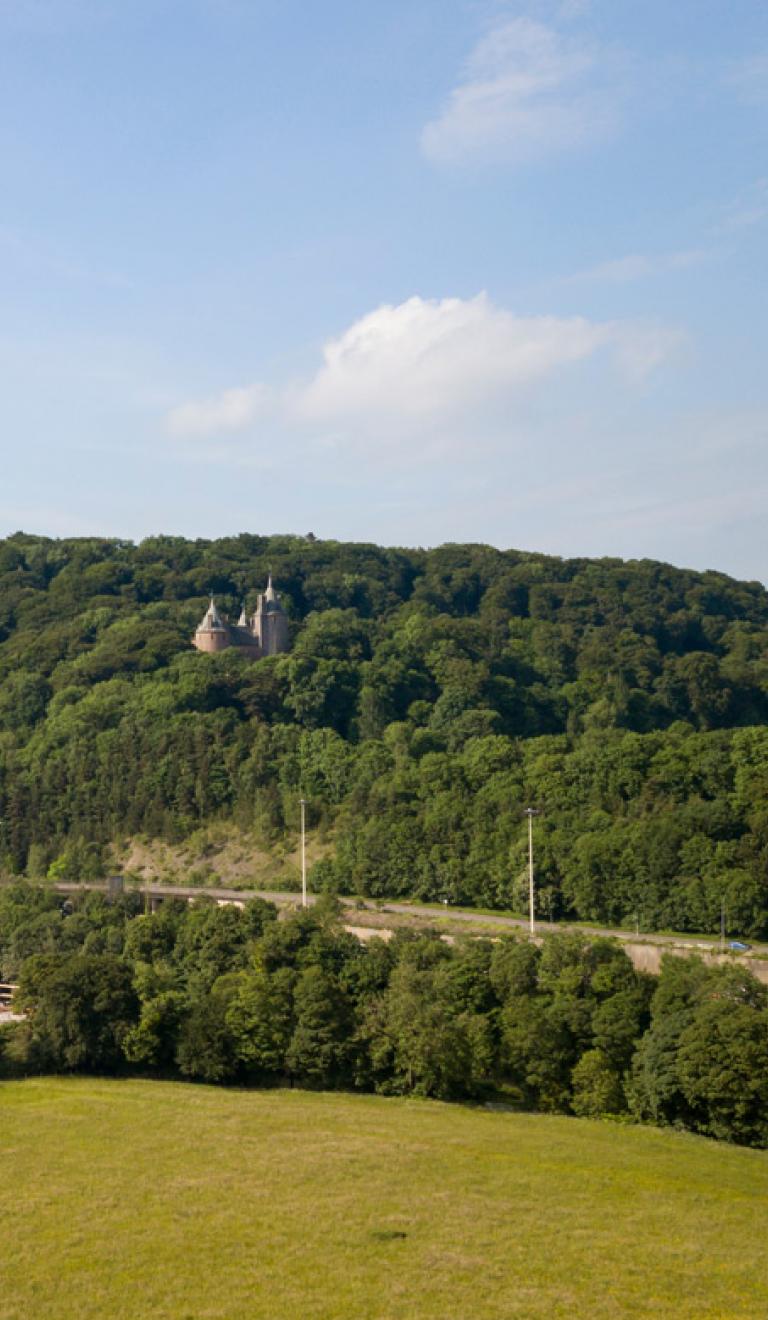 Landschaftsansicht mit Blick auf Castell Coch im Wald auf einem Hügel.