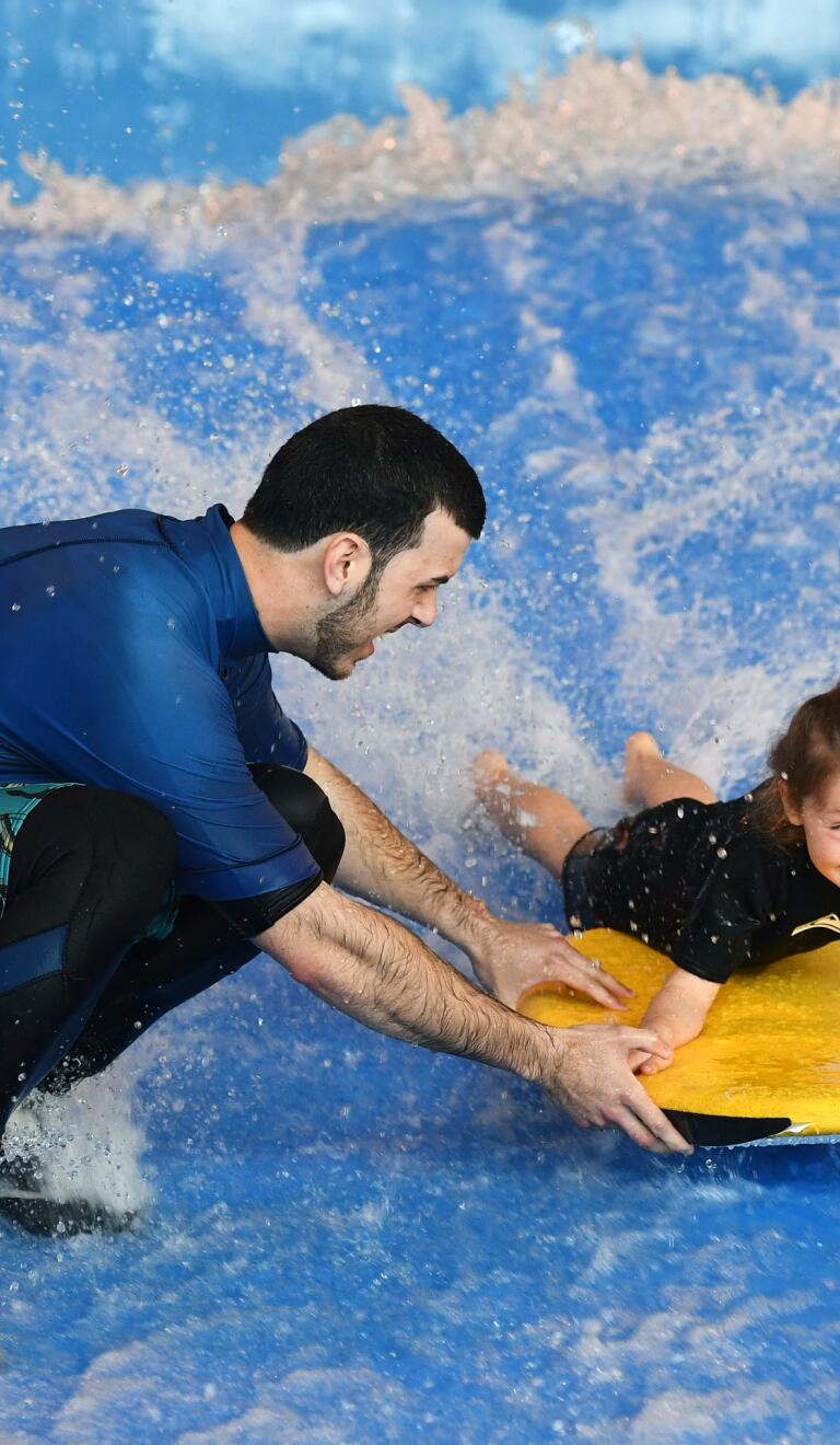 Young child body boarding at Cardiff International White Water