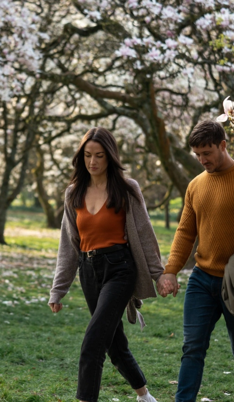 couple walking near blossoming trees in Bute Park, Cardiff