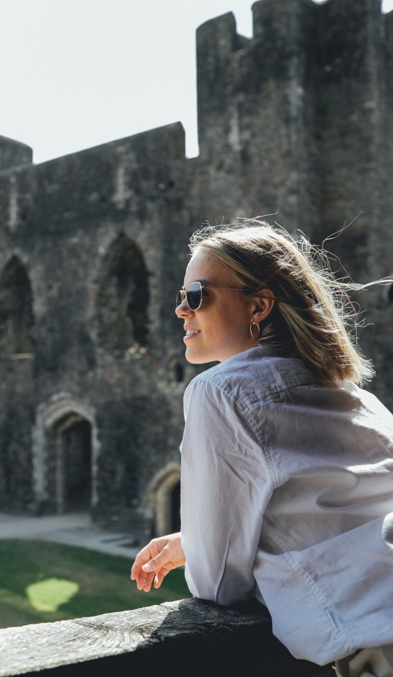 woman inside castle ruins.