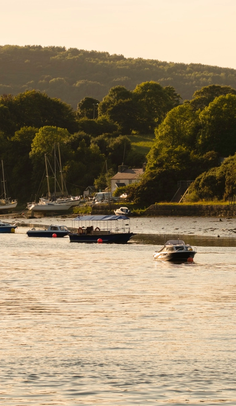 River Teifi in low light with boats on the river near a harbour..