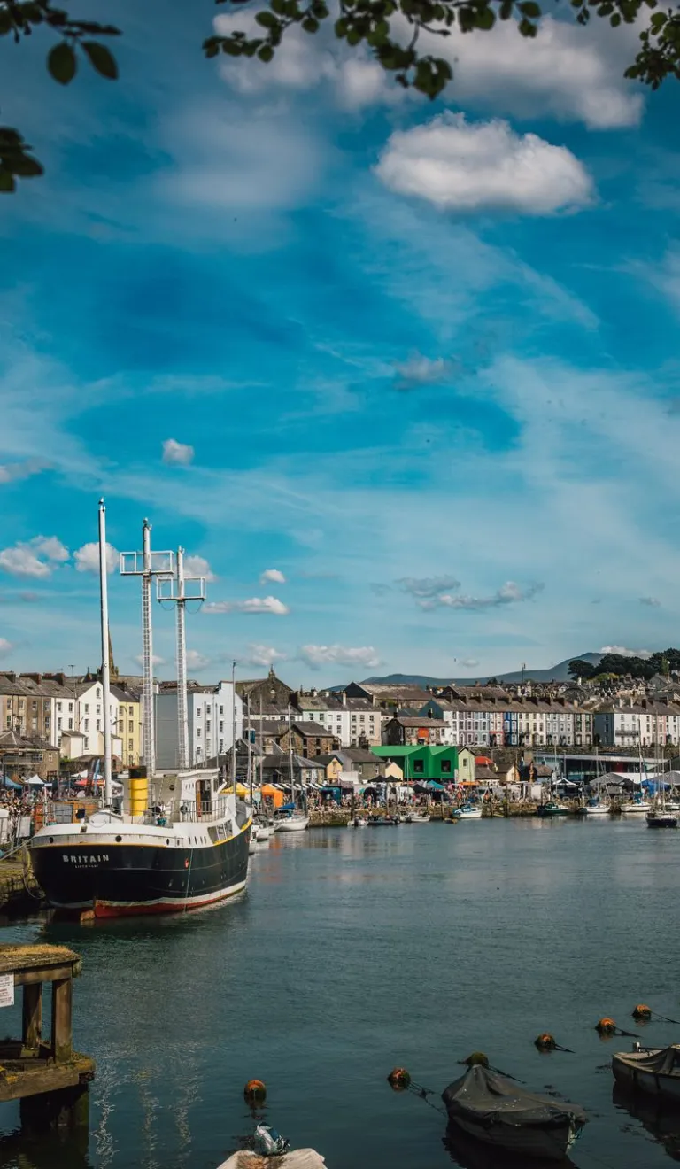 A pretty town with a castle, a quay with boats and old houses, and a food festival on.