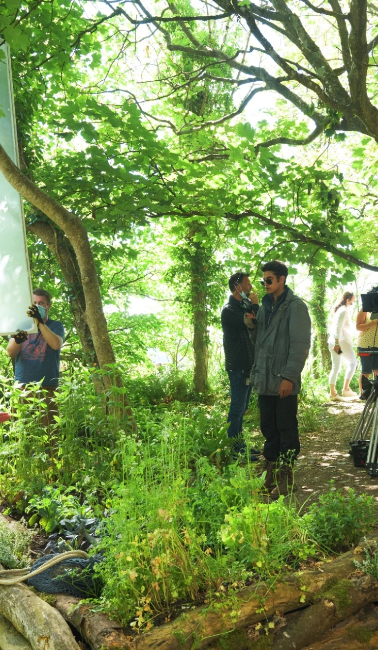 Film crew filming in woodland.